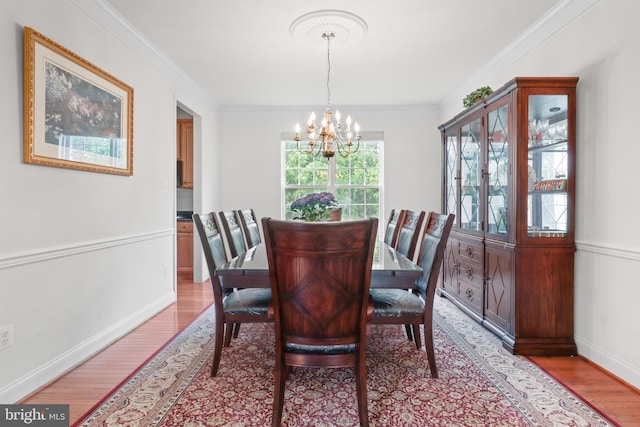 11404 Ramsburg Ct, North Potomac, MD 20878 - dining room with a chandelier, light wood-style flooring, baseboards, and crown molding