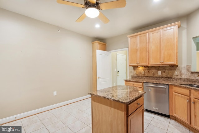 kitchen with decorative backsplash, dishwasher, ceiling fan, a center island, and light tile patterned floors