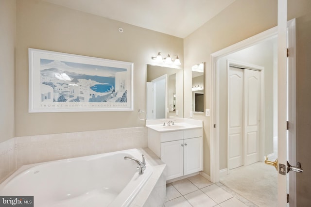 bathroom with vanity, tile patterned flooring, and a bath