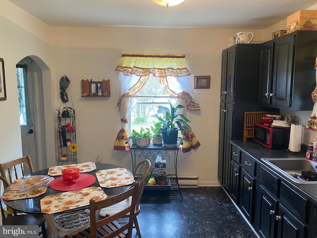 10092 Fay Ave, Seaford, DE 19973 - dining space with dark floors, arched walkways, baseboards, and baseboard heating