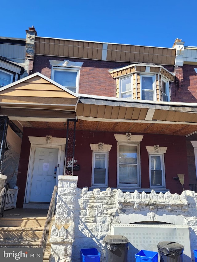 townhome / multi-family property with a porch