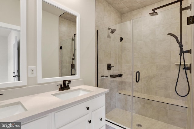 full bathroom with a shower stall and double vanity