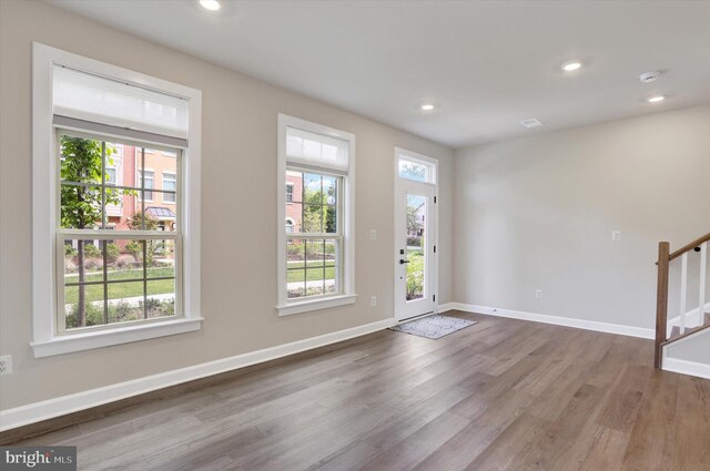 entrance foyer with dark wood-type flooring, recessed lighting, stairway, and baseboards