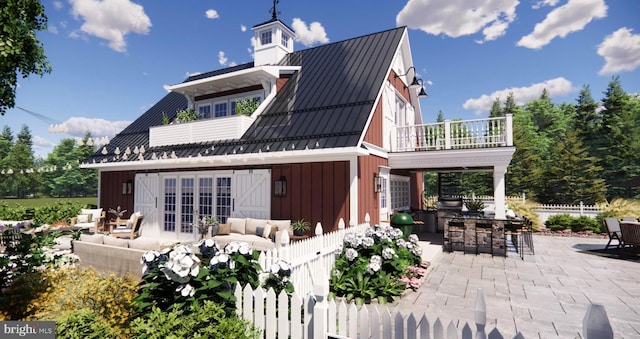 rear view of house with outdoor dry bar, an outdoor living space, a standing seam roof, a patio, and metal roof