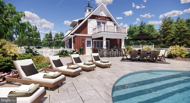 rear view of house with board and batten siding, outdoor dry bar, a patio area, fence, and a balcony