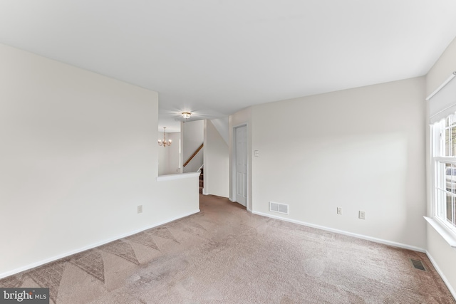 493 Stoneglen St, Collegeville, PA 19426 - carpeted spare room featuring baseboards, a notable chandelier, stairs, and visible vents