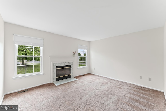 493 Stoneglen St, Collegeville, PA 19426 - unfurnished living room with a high end fireplace, baseboards, carpet, and visible vents