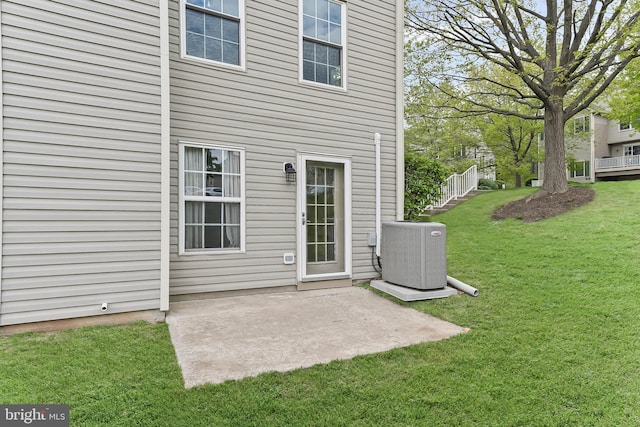 493 Stoneglen St, Collegeville, PA 19426 - back of property with a yard, central AC unit, and a patio area