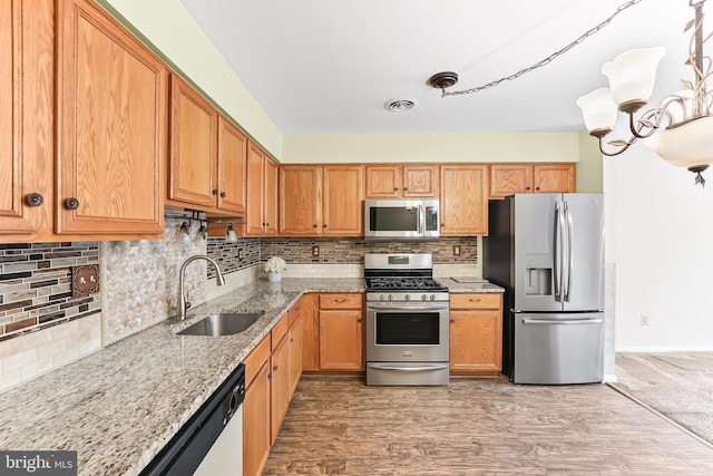 493 Stoneglen St, Collegeville, PA 19426 - kitchen featuring visible vents, decorative backsplash, light stone countertops, a sink, and stainless steel appliances