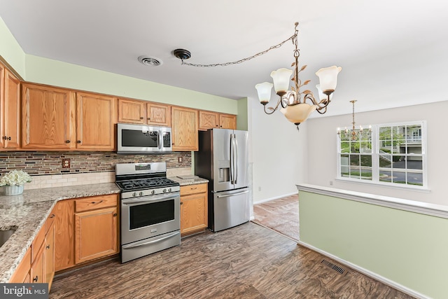 493 Stoneglen St, Collegeville, PA 19426 - kitchen featuring an inviting chandelier, decorative backsplash, appliances with stainless steel finishes, and visible vents