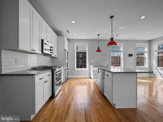 106-12 W Jefferson St Unit 2, Philadelphia, PA 19122 - kitchen with a sink, stainless steel appliances, light wood finished floors, plenty of natural light, and baseboards