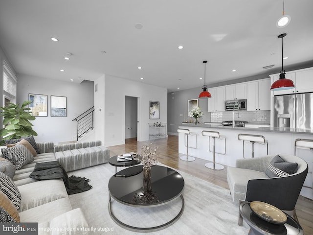 106-12 W Jefferson St Unit 2, Philadelphia, PA 19122 - living area with light wood-style floors, stairway, baseboards, and recessed lighting