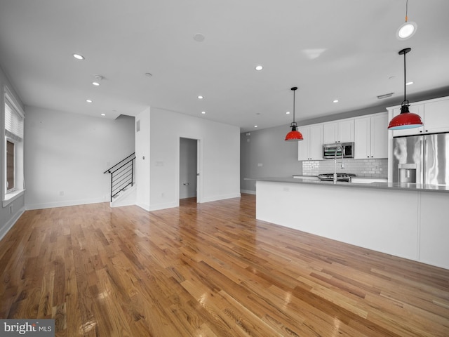 106-12 W Jefferson St Unit 2, Philadelphia, PA 19122 - kitchen featuring recessed lighting, white cabinetry, open floor plan, and appliances with stainless steel finishes