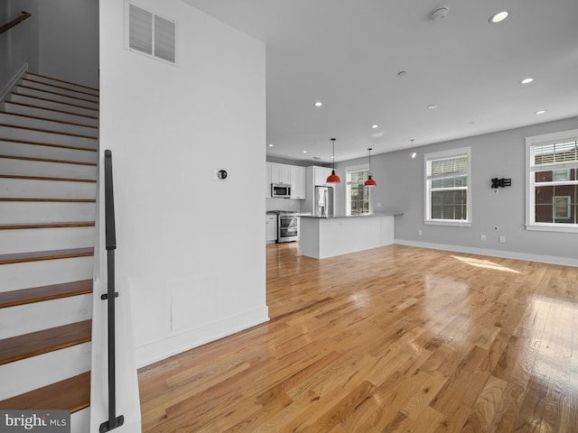 106-12 W Jefferson St Unit 2, Philadelphia, PA 19122 - unfurnished living room featuring light wood-type flooring, stairway, visible vents, and recessed lighting