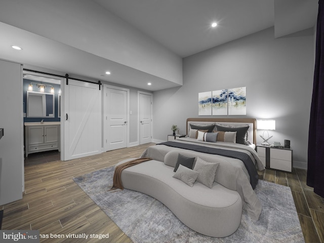 106-12 W Jefferson St Unit 2, Philadelphia, PA 19122 - bedroom with recessed lighting, a barn door, and wood finished floors