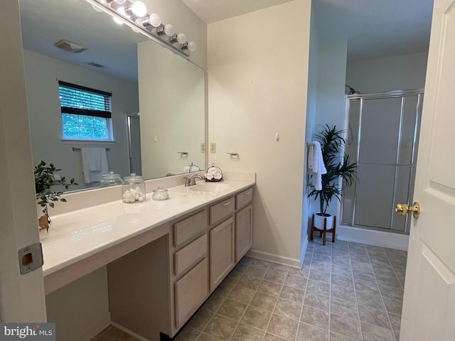full bathroom with vanity, baseboards, and a shower stall