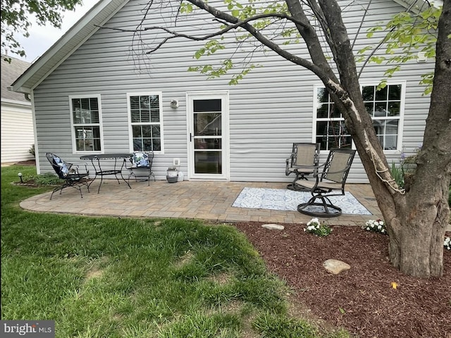 rear view of property with a patio and a yard