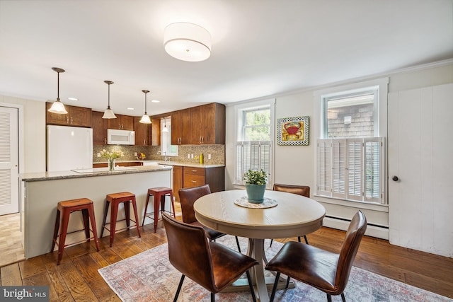 dining room with recessed lighting, dark wood finished floors, and a baseboard radiator
