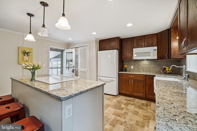 kitchen with stone finish floor, decorative backsplash, a sink, ornamental molding, and white appliances