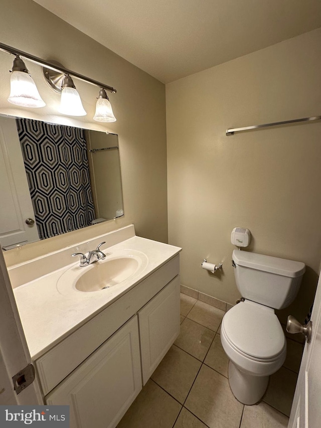 bathroom featuring vanity, tile patterned flooring, and toilet