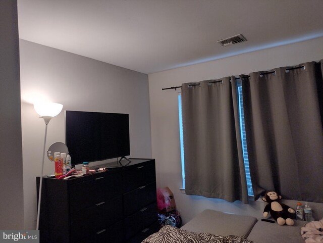 bedroom featuring visible vents