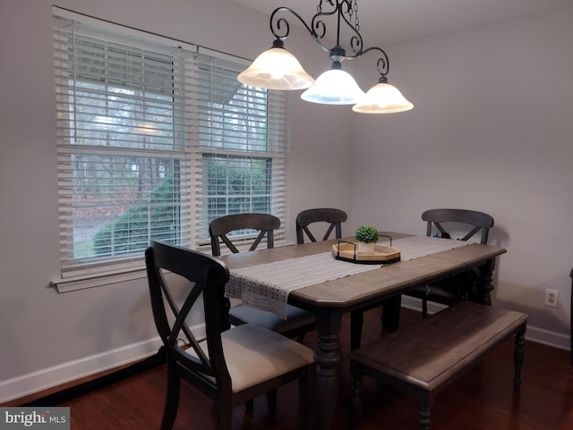 dining area featuring baseboards and wood finished floors
