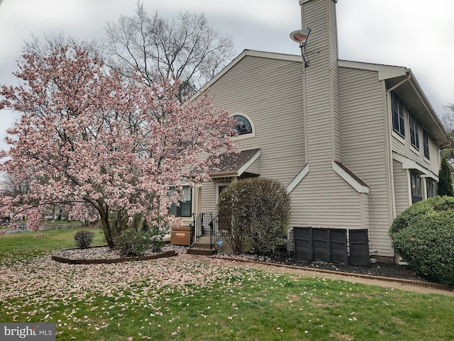 exterior space with a lawn and a chimney