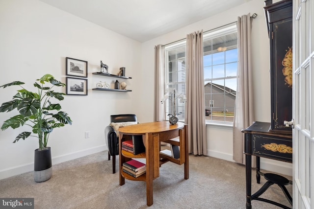 dining space with a healthy amount of sunlight, baseboards, and light carpet