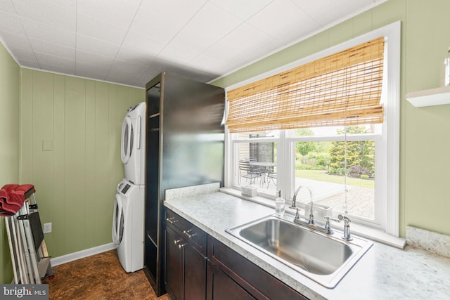 111 Heron Ln, Augusta, WV 26704 - kitchen featuring a sink, stacked washer and clothes dryer, and light countertops