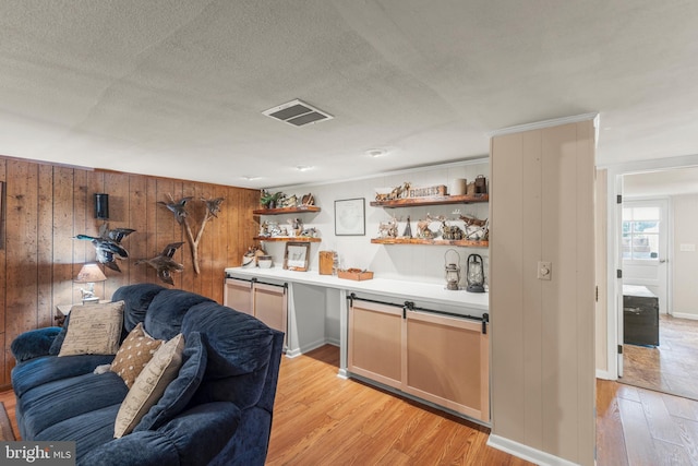 111 Heron Ln, Augusta, WV 26704 - bar with light wood finished floors, wooden walls, a textured ceiling, and baseboards