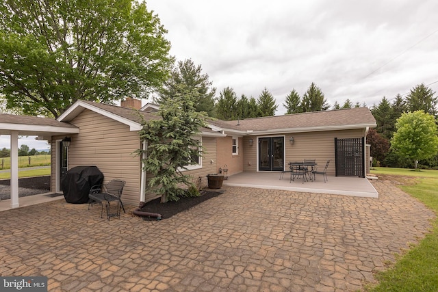 111 Heron Ln, Augusta, WV 26704 - rear view of house with a patio area and a chimney
