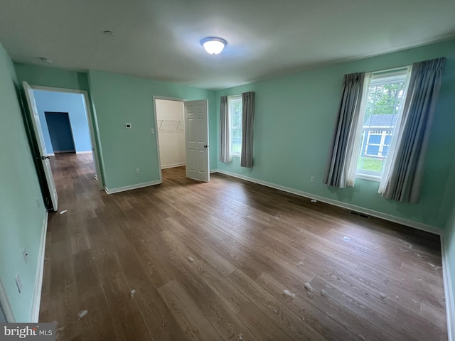 16722 Custer Ct, Williamsport, MD 21795 - unfurnished bedroom featuring dark wood-style flooring, baseboards, visible vents, and multiple windows