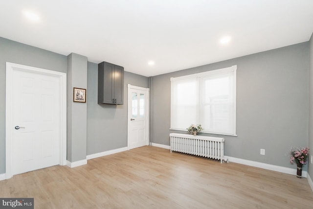 entryway featuring baseboards, recessed lighting, radiator heating unit, and light wood-type flooring