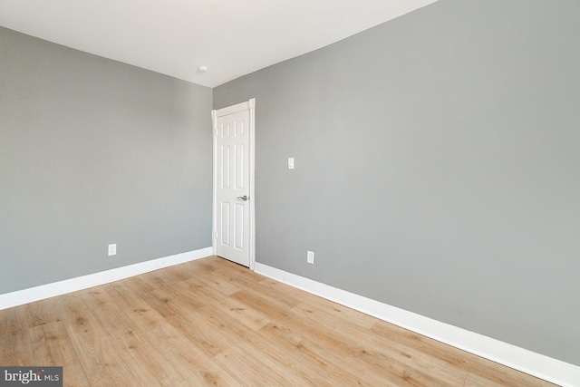 unfurnished room featuring light wood-style floors and baseboards