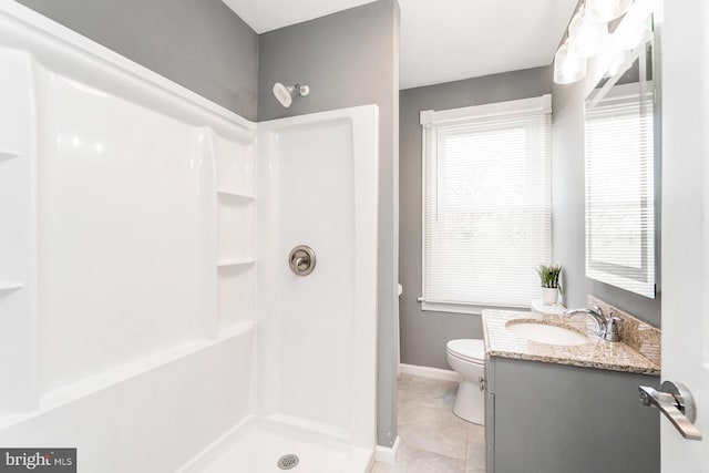 full bathroom with toilet, a healthy amount of sunlight, a shower, and vanity