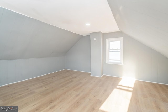 bonus room with vaulted ceiling and wood finished floors