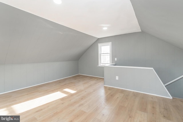 bonus room featuring lofted ceiling and wood finished floors