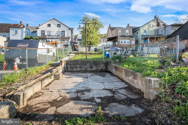 view of patio with fence and a residential view