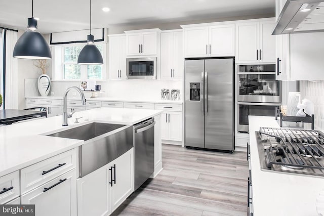 2682 Broadhorn Dr, Odenton, MD 21113 - kitchen featuring appliances with stainless steel finishes, a sink, light countertops, white cabinetry, and range hood