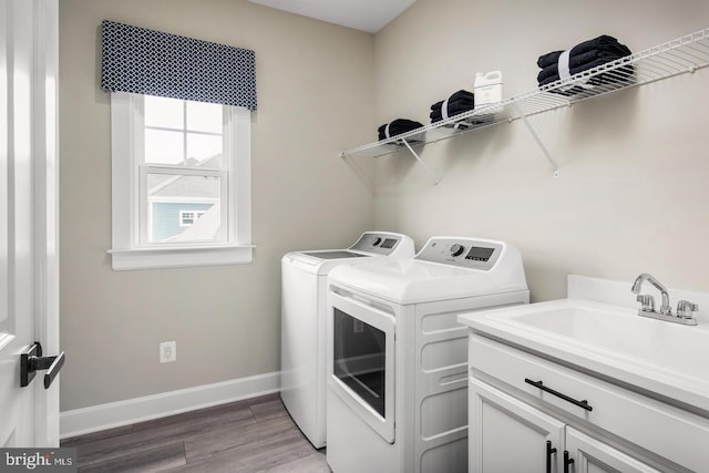 2682 Broadhorn Dr, Odenton, MD 21113 - washroom with washing machine and dryer, light wood-style floors, baseboards, a sink, and cabinet space