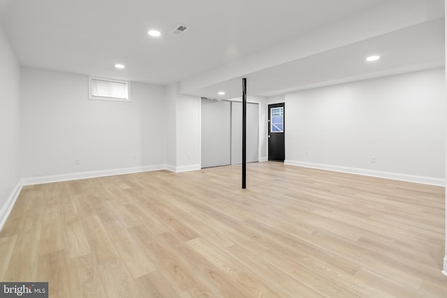 basement with light wood-style floors, baseboards, and recessed lighting