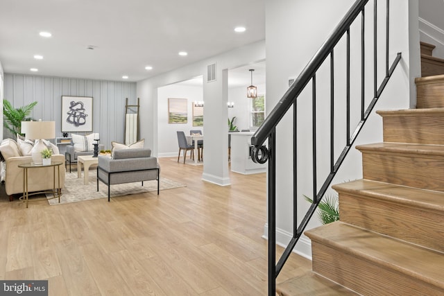 living area with stairway, light wood-type flooring, recessed lighting, and visible vents