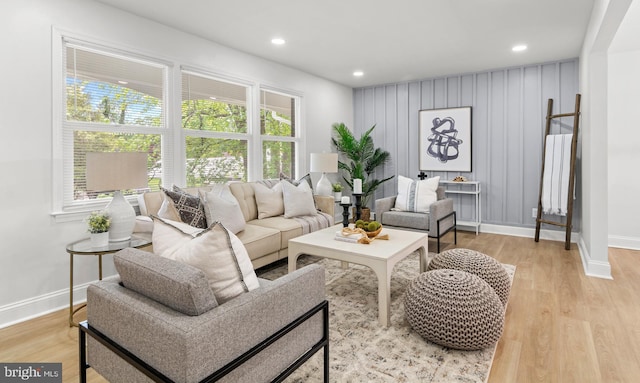 living room featuring baseboards, recessed lighting, and light wood-style floors