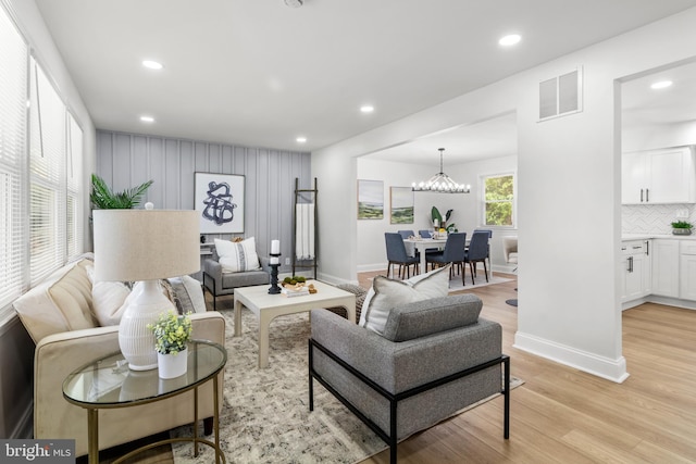 living area with recessed lighting, visible vents, and light wood-style flooring