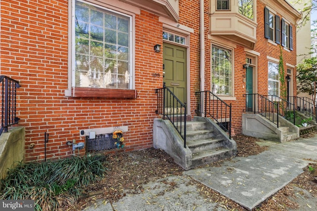 property entrance featuring brick siding
