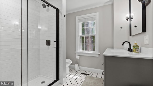 full bath featuring crown molding, vanity, toilet, baseboards, and a stall shower