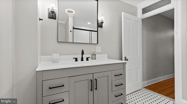 bathroom with vanity, baseboards, and ornamental molding