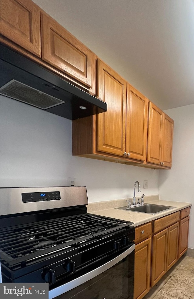 7521 Riverdale Rd Unit 1979, New Carrollton, MD 20784 - kitchen featuring a sink, under cabinet range hood, gas stove, and light countertops