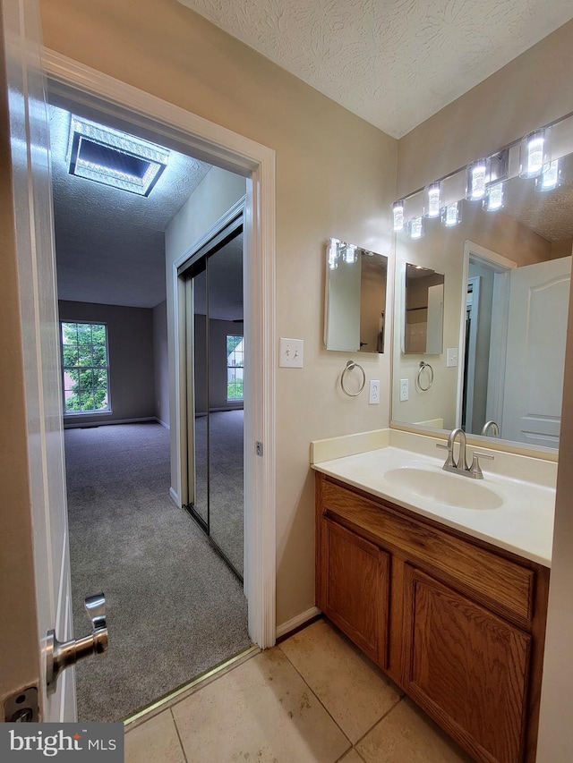 3707 Elmcrest Ln, Bowie, MD 20716 - bathroom with a textured ceiling, vanity, tile patterned floors, and baseboards
