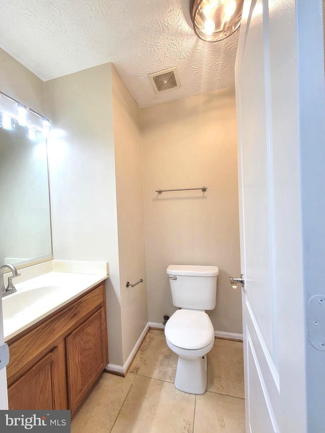 3707 Elmcrest Ln, Bowie, MD 20716 - half bath with vanity, toilet, tile patterned floors, baseboards, and a textured ceiling
